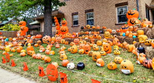 Front of a house in College Hill with a bunch of jack-o-lanterns and haybales littering the yard