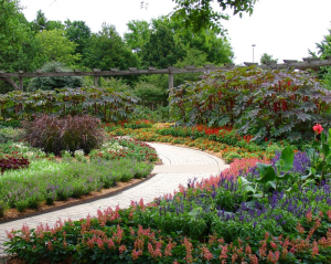 A path going through Botanica Gardens in Wichita Kansas where flowers and plants grow 