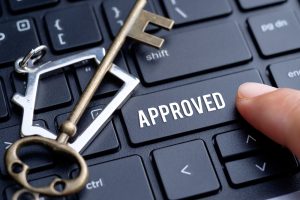 New home keys next to a button saying, "Approved"